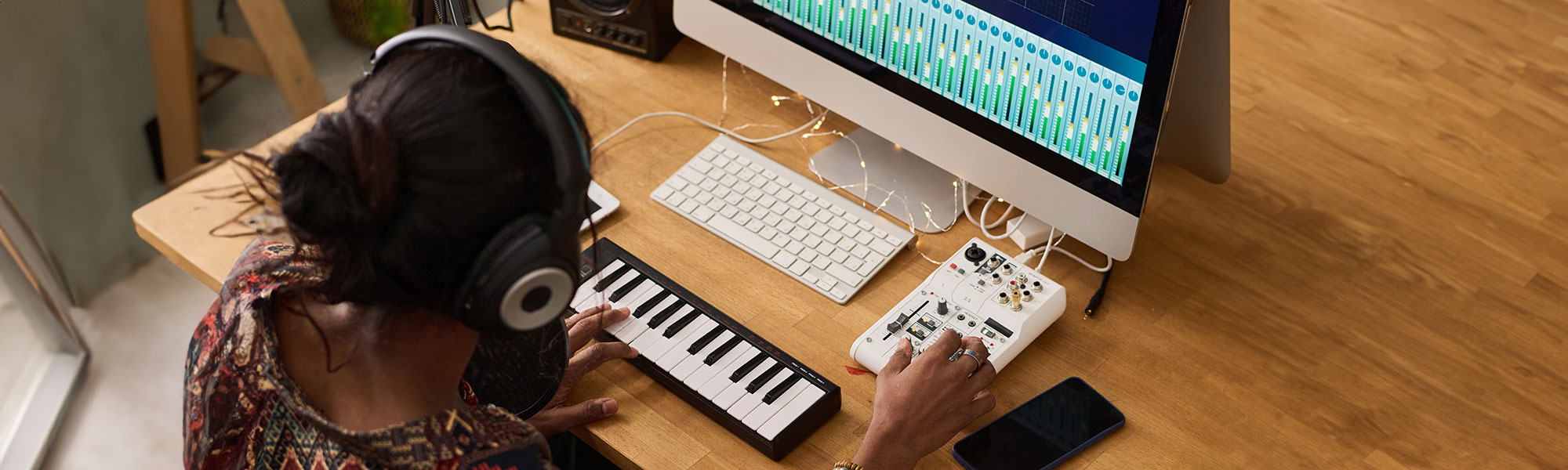 woman on keyboard and macbook playing music